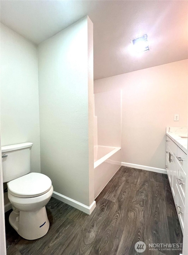 6321 Central Park Dr, Aberdeen, WA 98520 - full bath featuring wood finished floors, toilet, vanity, baseboards, and a bathtub
