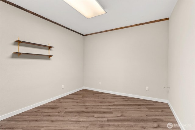6044 Buckthorn Ct NW, Olympia, WA 98502 - empty room featuring baseboards, wood finished floors, and crown molding