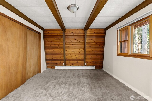 6044 Buckthorn Ct NW, Olympia, WA 98502 - carpeted spare room with beamed ceiling, baseboards, wood walls, and a baseboard radiator