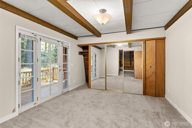 6044 Buckthorn Ct NW, Olympia, WA 98502 - unfurnished bedroom featuring baseboards, access to outside, beamed ceiling, and carpet
