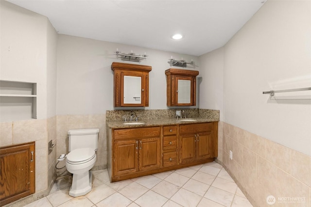 6044 Buckthorn Ct NW, Olympia, WA 98502 - bathroom featuring tile walls, a wainscoted wall, and a sink