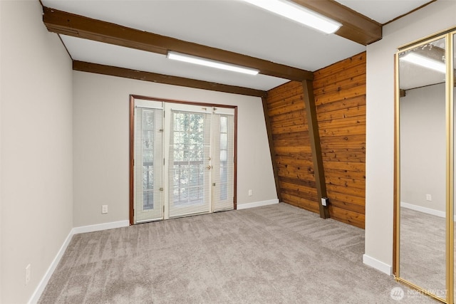 6044 Buckthorn Ct NW, Olympia, WA 98502 - carpeted spare room featuring wooden walls, beam ceiling, and baseboards