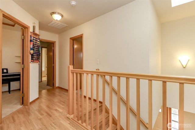 5475 Park Place Loop SE, Lacey, WA 98503 - hallway with an upstairs landing, light wood finished floors, and a skylight