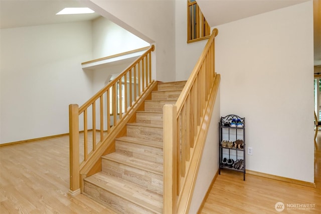 5475 Park Place Loop SE, Lacey, WA 98503 - stairs featuring wood finished floors, a skylight, and baseboards