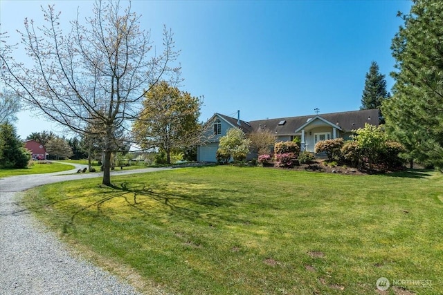 30729 76th Ave NW, Stanwood, WA 98292 - ranch-style house with an attached garage, gravel driveway, and a front lawn