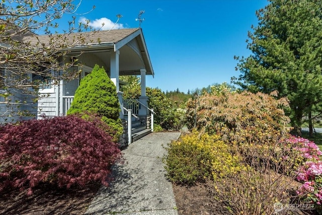 30729 76th Ave NW, Stanwood, WA 98292 - view of side of property featuring roof with shingles and a porch