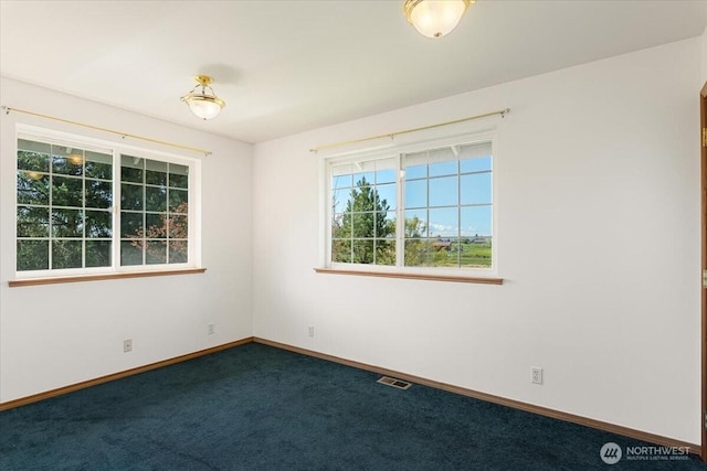 30729 76th Ave NW, Stanwood, WA 98292 - spare room with dark carpet, visible vents, and baseboards