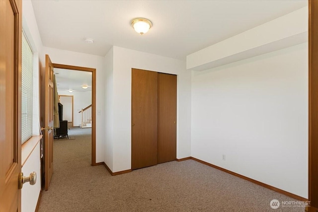 30729 76th Ave NW, Stanwood, WA 98292 - unfurnished bedroom featuring light carpet, a closet, and baseboards