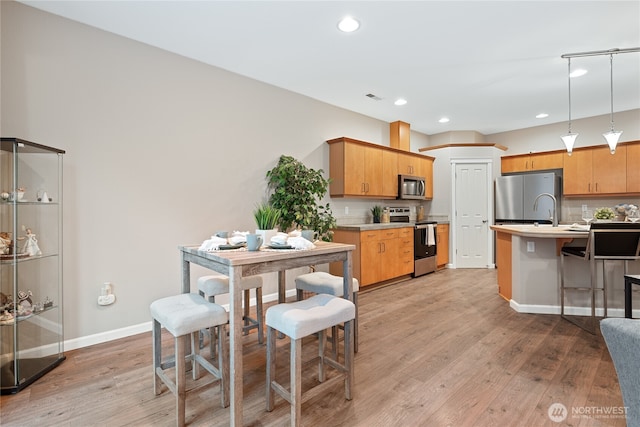 2202 NE 140th St Lot 44, Vancouver, WA 98686 - kitchen with visible vents, light wood-style flooring, appliances with stainless steel finishes, and light countertops