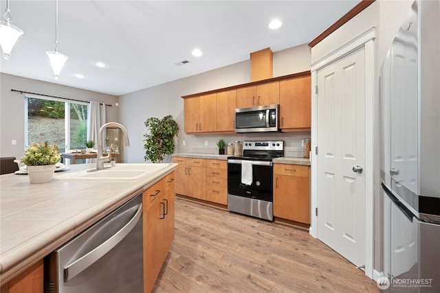 2202 NE 140th St Lot 44, Vancouver, WA 98686 - kitchen featuring pendant lighting, light wood-style flooring, a sink, appliances with stainless steel finishes, and visible vents