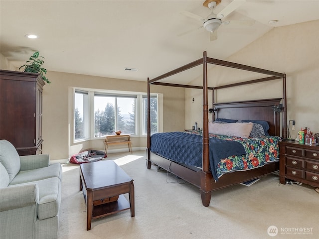 bedroom featuring lofted ceiling, visible vents, baseboards, and light carpet