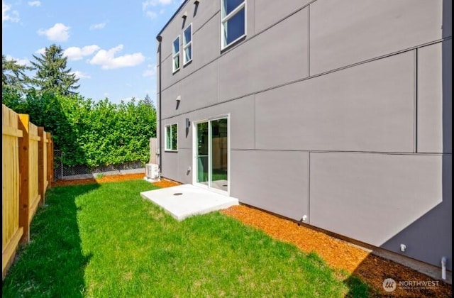 exterior space featuring a lawn and fence