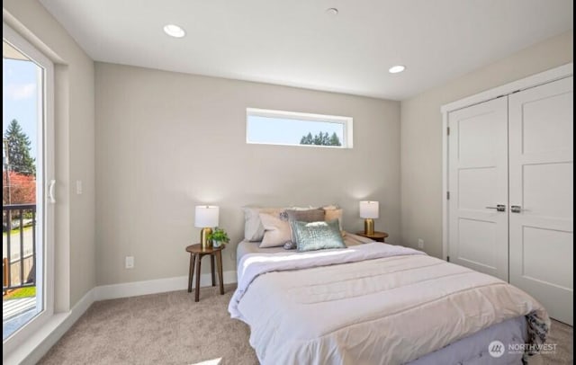 bedroom with baseboards, recessed lighting, a closet, and light colored carpet