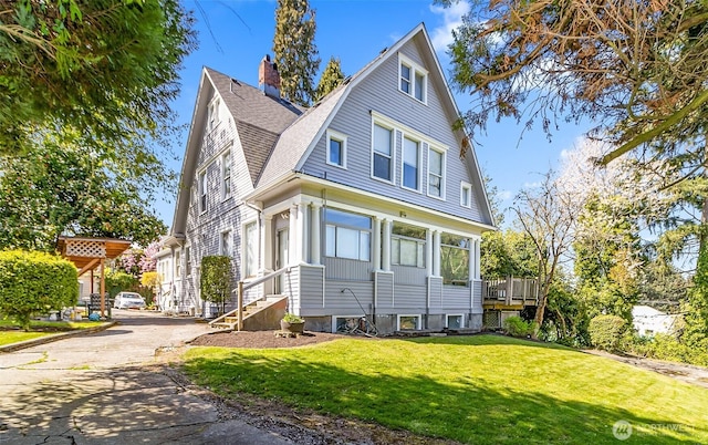 3512 Grand Ave, Everett, WA 98201 - view of front facade featuring a gambrel roof, a chimney, driveway, roof with shingles, and a front yard