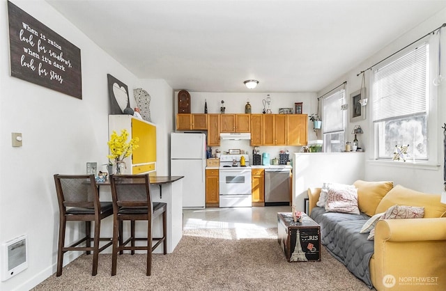 3512 Grand Ave, Everett, WA 98201 - kitchen with heating unit, brown cabinetry, open floor plan, white appliances, and under cabinet range hood