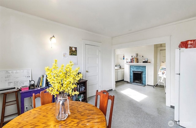 3512 Grand Ave, Everett, WA 98201 - dining room featuring a fireplace with flush hearth, baseboards, and crown molding