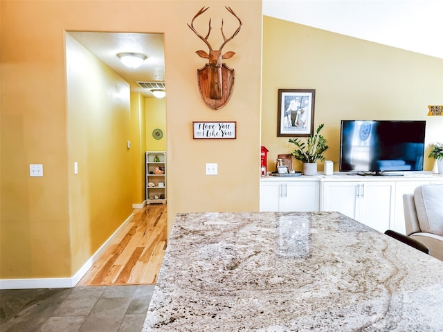 interior space with baseboards and visible vents