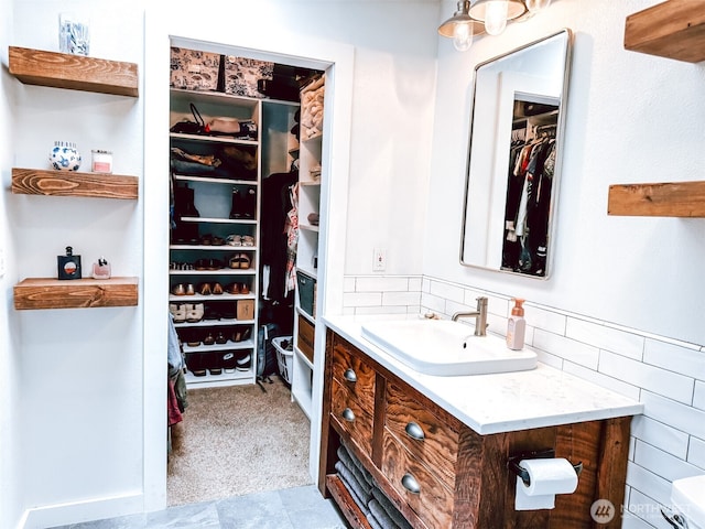 bathroom featuring vanity and a spacious closet