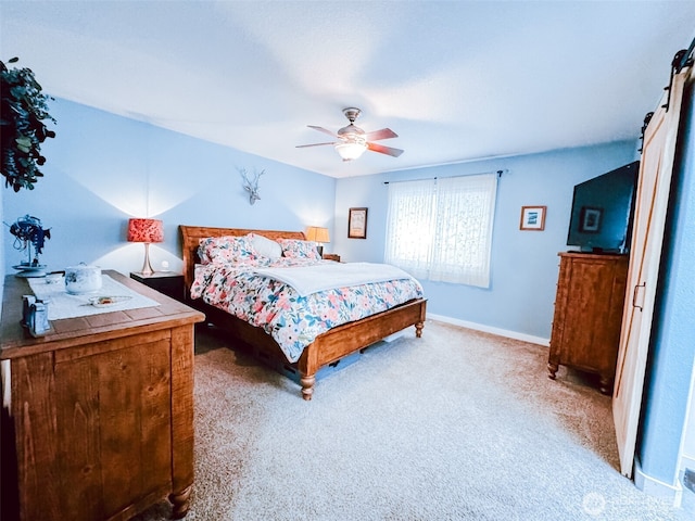 bedroom featuring a ceiling fan, baseboards, and light carpet