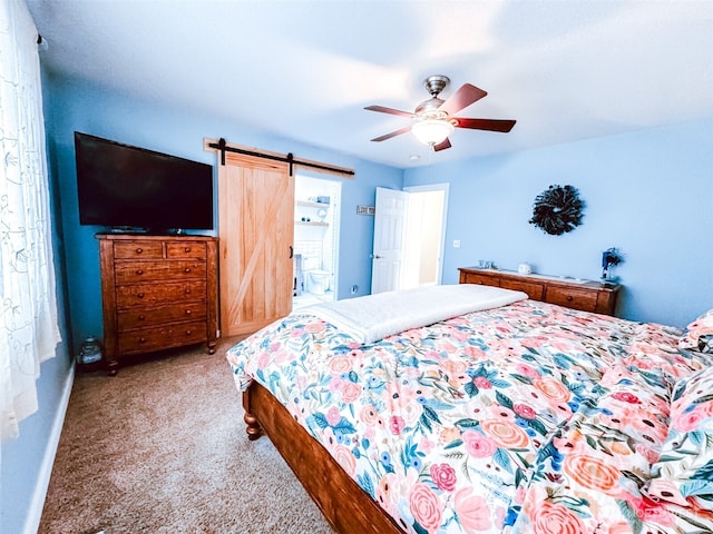 carpeted bedroom with baseboards, a barn door, and a ceiling fan