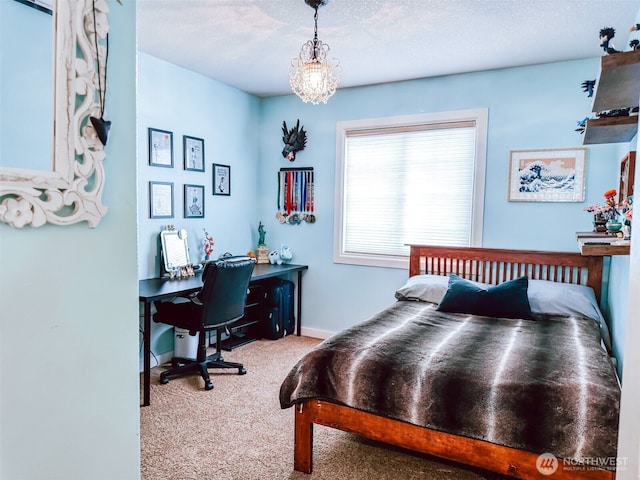 bedroom featuring carpet flooring, baseboards, and a notable chandelier
