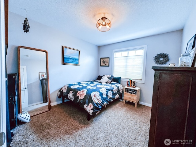 carpeted bedroom featuring a textured ceiling and baseboards