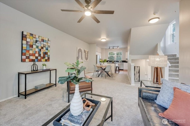 3116 164th St SW Unit 2101, Lynnwood, WA 98087 - living room featuring ceiling fan, carpet floors, stairway, and baseboards