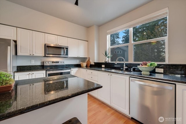 3116 164th St SW Unit 2101, Lynnwood, WA 98087 - kitchen with stainless steel appliances, a sink, white cabinets, and dark stone countertops