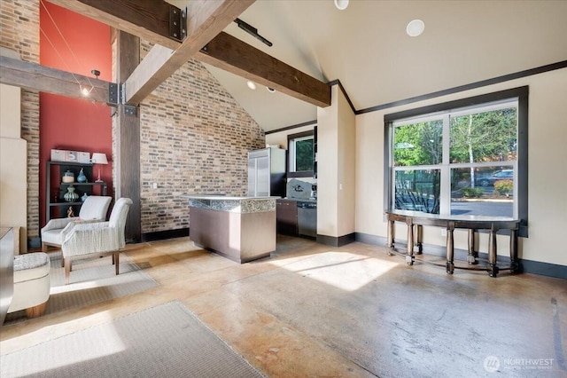 3116 164th St SW Unit 2101, Lynnwood, WA 98087 - living area featuring finished concrete flooring, baseboards, brick wall, high vaulted ceiling, and beamed ceiling