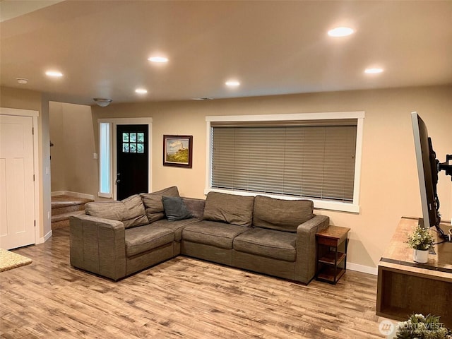 living area featuring wood finished floors, baseboards, and recessed lighting