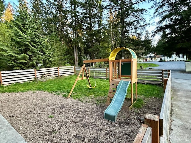 view of jungle gym featuring a yard and fence