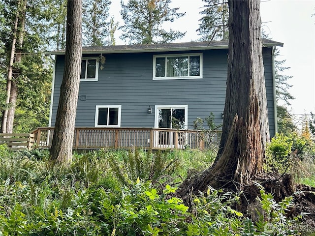back of house featuring a deck