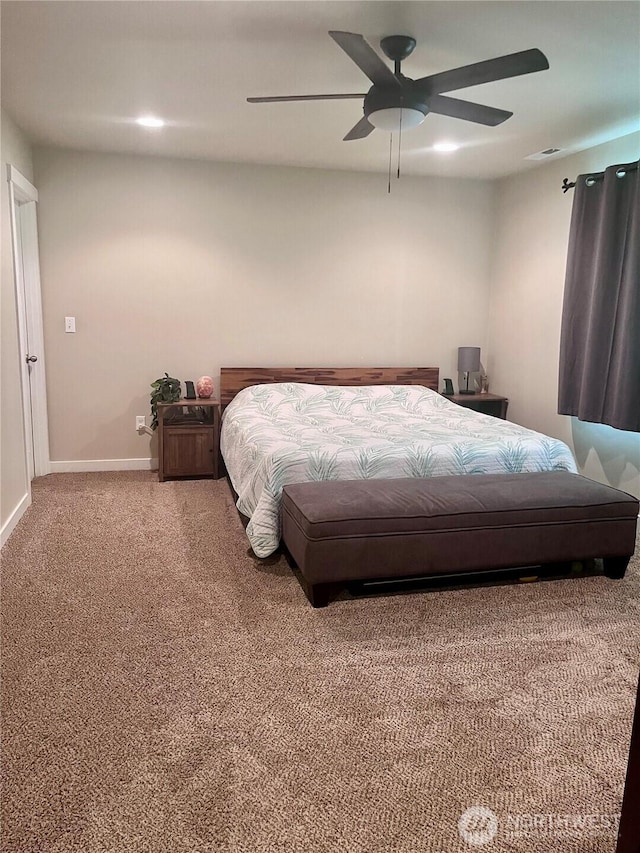 carpeted bedroom with ceiling fan and baseboards