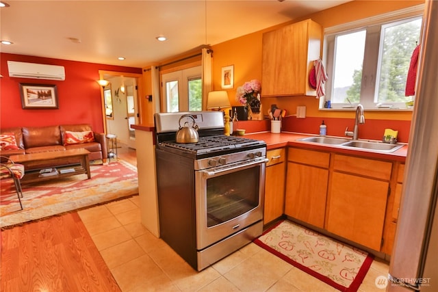 240 Mcfarland Creek Rd, Methow, WA 98834 - kitchen with a sink, gas stove, a wall mounted AC, and recessed lighting