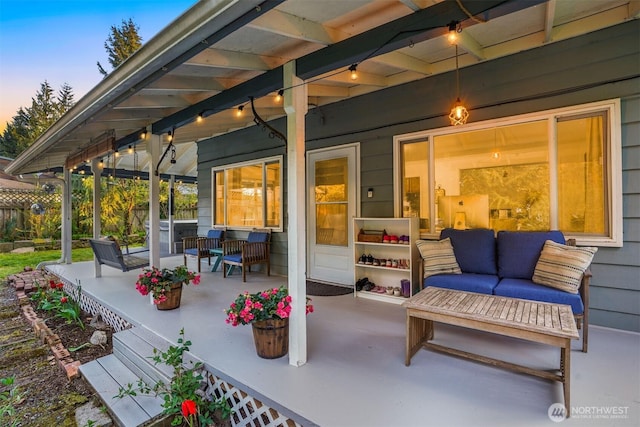 patio terrace at dusk with a porch and an outdoor hangout area