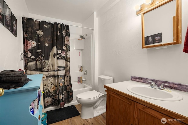 bathroom featuring shower / tub combo with curtain, wood finished floors, vanity, and toilet