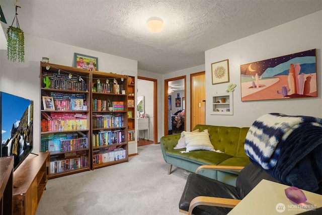living area with carpet flooring and a textured ceiling