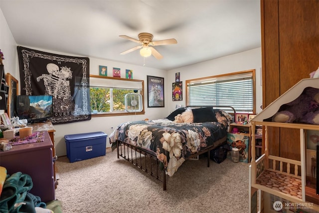 bedroom with carpet floors, a ceiling fan, and multiple windows