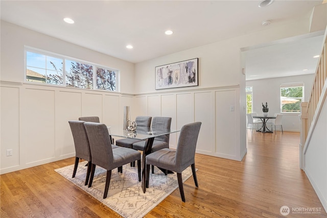 10788 243rd Ave NE, Redmond, WA 98053 - dining space featuring a decorative wall, light wood-style flooring, a wainscoted wall, and recessed lighting
