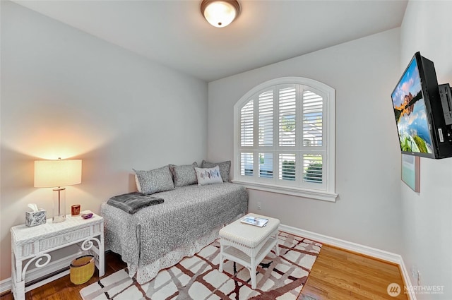 bedroom featuring baseboards and wood finished floors