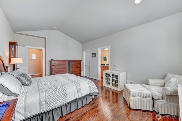 bedroom with baseboards, vaulted ceiling, hardwood / wood-style flooring, and visible vents