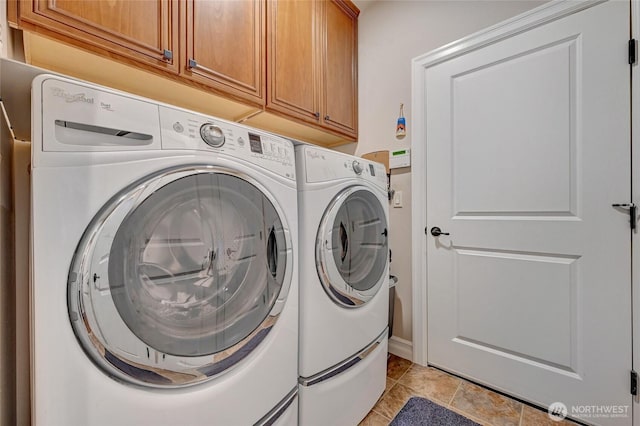 laundry area featuring cabinet space, independent washer and dryer, and light tile patterned floors
