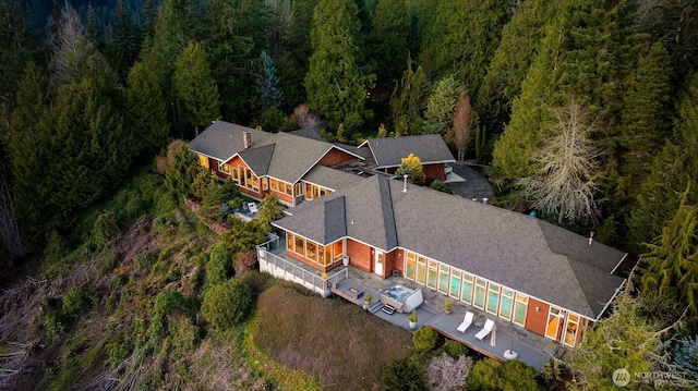 bird's eye view with a wooded view