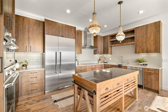 kitchen with stainless steel appliances, a sink, decorative backsplash, wall chimney range hood, and open shelves