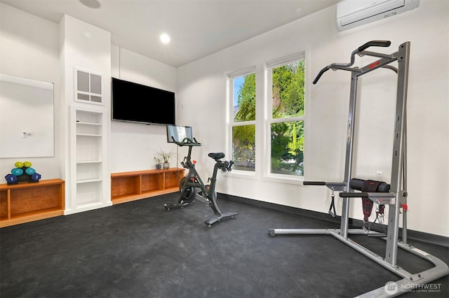 exercise area featuring baseboards, visible vents, recessed lighting, and a wall mounted air conditioner