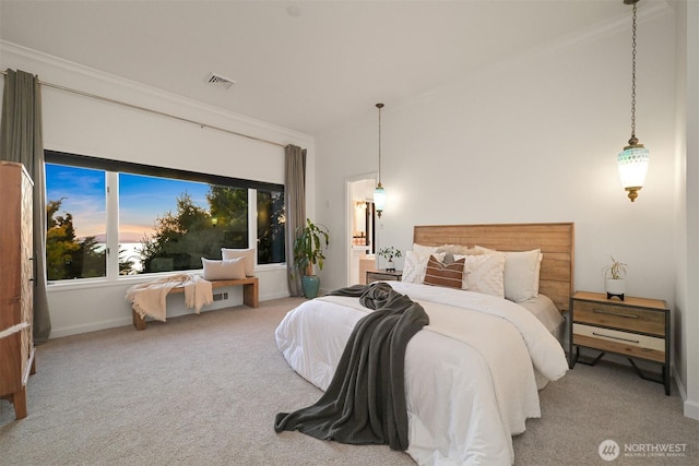 carpeted bedroom with baseboards, crown molding, and visible vents