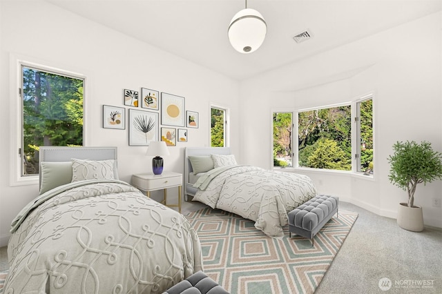 carpeted bedroom with baseboards and visible vents
