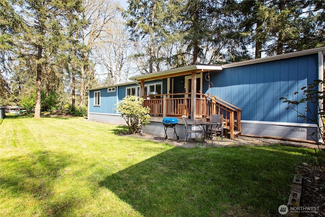 rear view of property with a yard and a deck