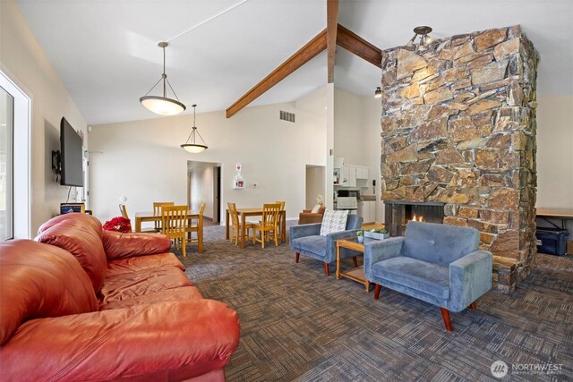 living room with carpet, beam ceiling, high vaulted ceiling, and a stone fireplace