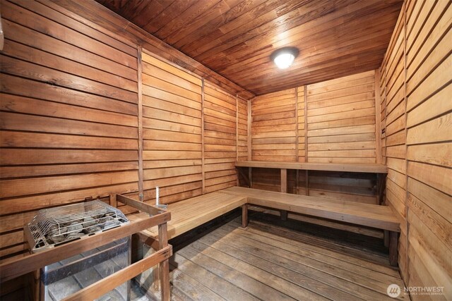 sauna / steam room featuring wooden ceiling, wooden walls, and wood-type flooring